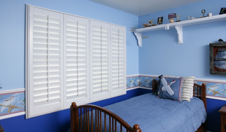 Blue kids bedroom with white plantation shutters in Phoenix 